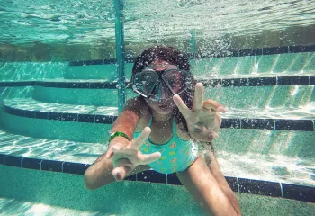 person swimming under water during daytime