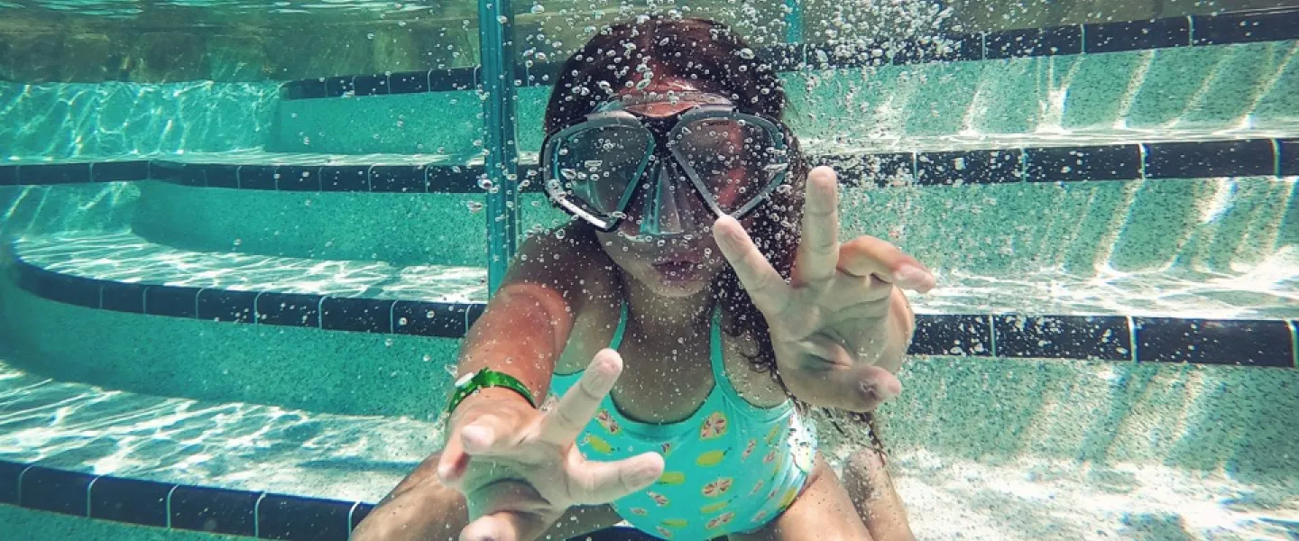 person swimming under water during daytime
