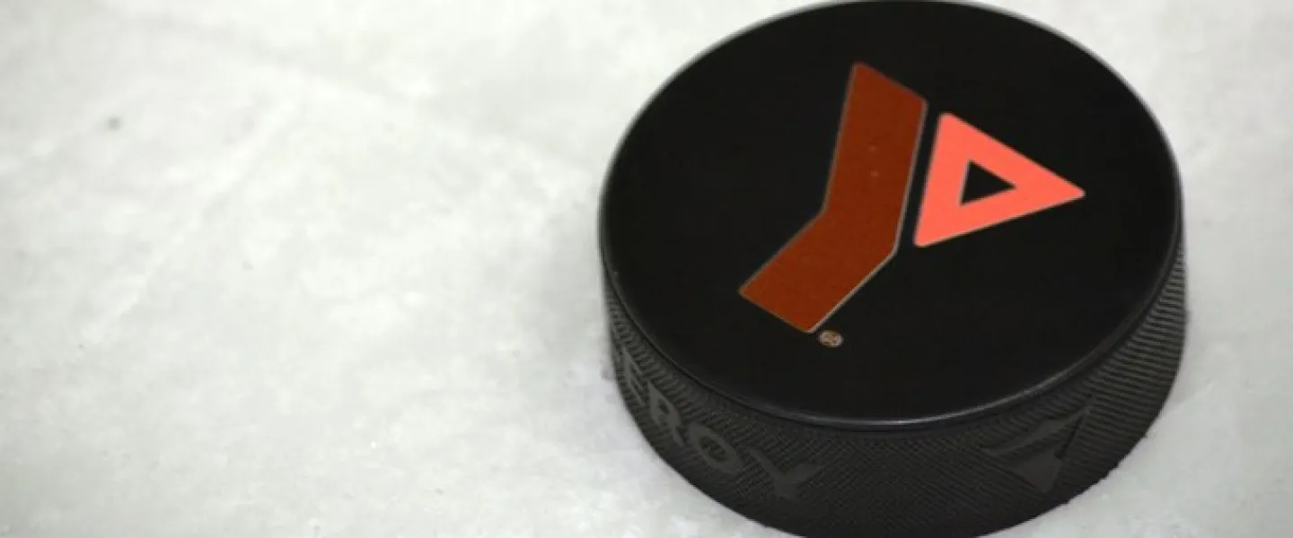 A hockey puck with the Y logo