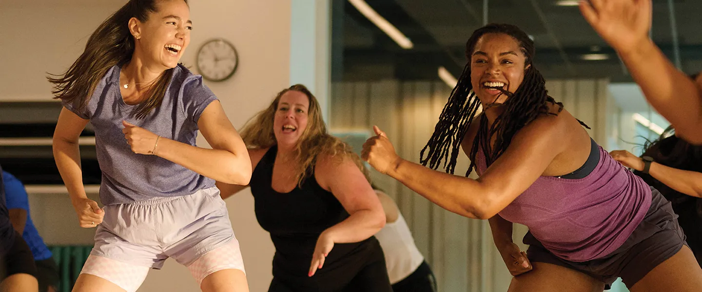 Several women engaged in a dance class, demonstrating different movements and enjoying the rhythm together.