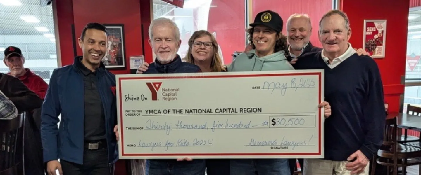 Six people holding a large cheque to the YMCA of the National Capital Region for $30,500.