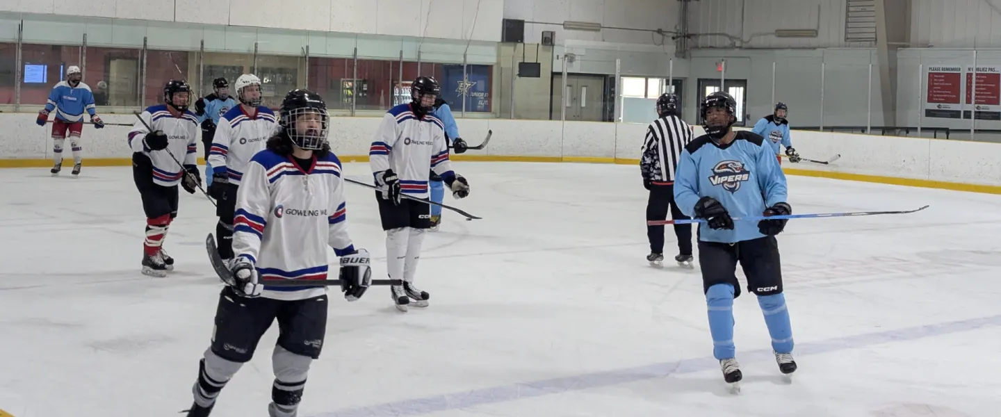 Two hockey team skating on an ice rink