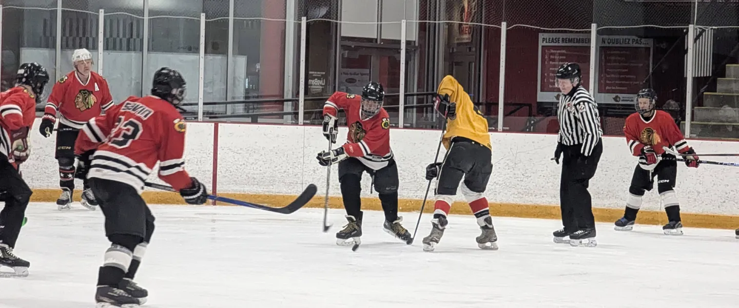 Two hockey teams playing on the ice