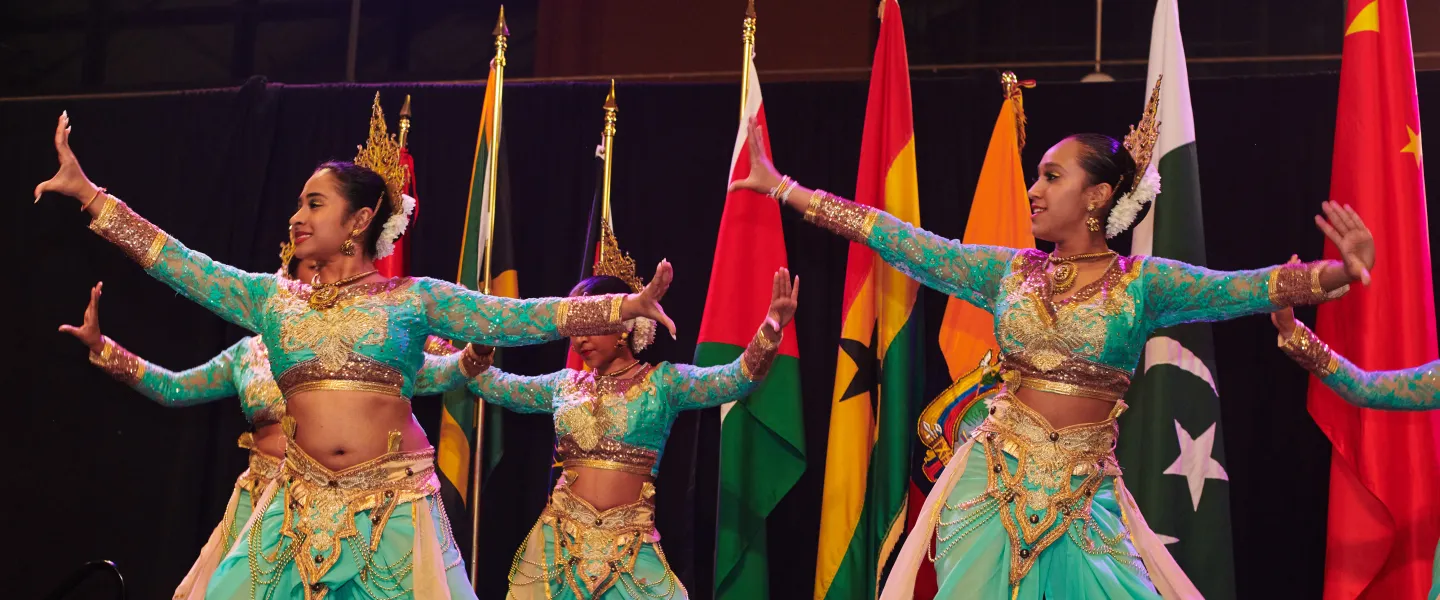 Rhythmic Nritya Foundation dancers performing onstage in traditional attire