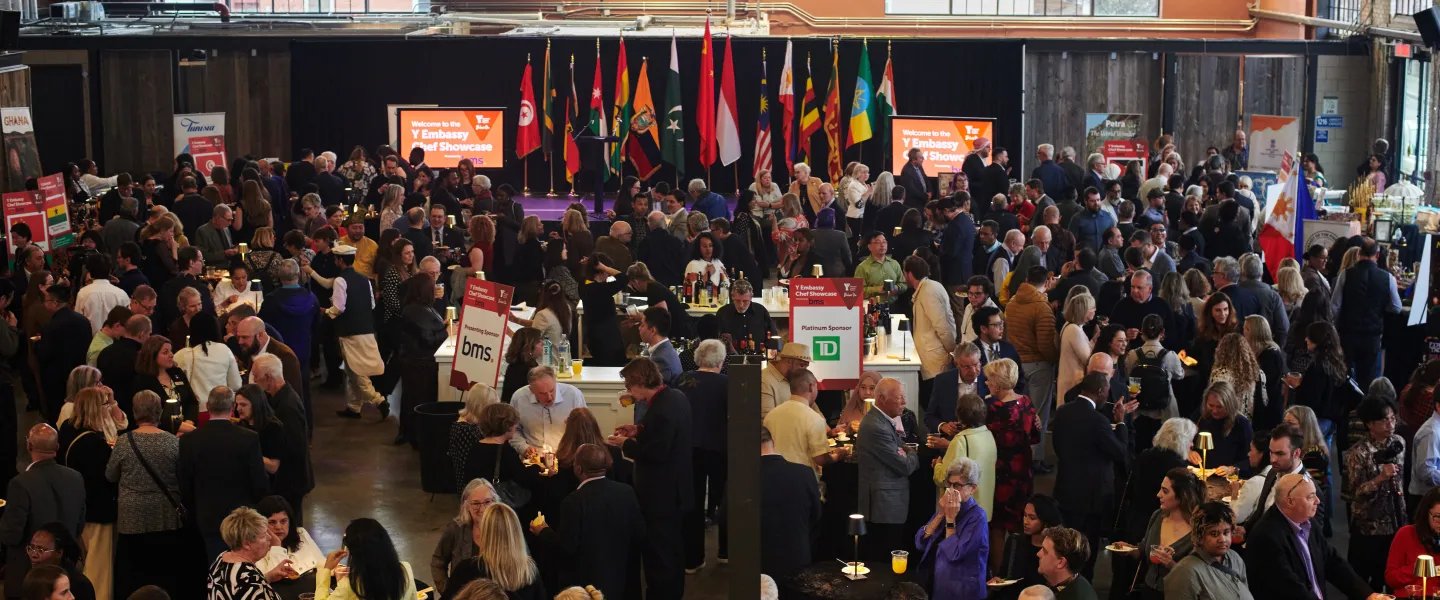 The Horticulture Building full of event attendees mingling and visiting cultural booths