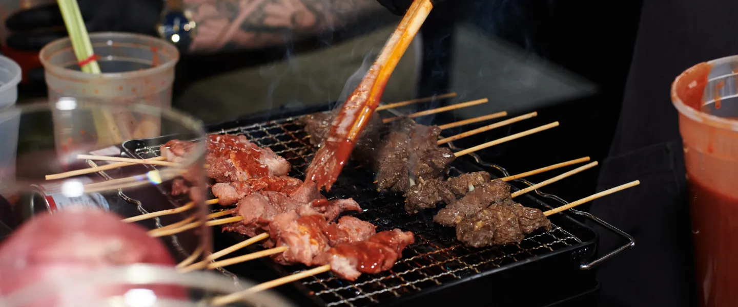 A chef preparing grilled meats