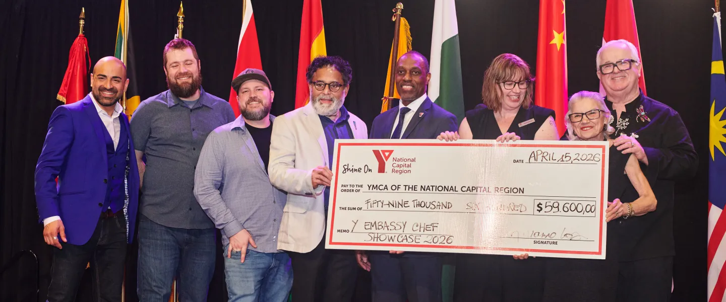 Y Embassy Chef Showcase judges, emcees, and YMCA team members holding a large cheque for $59,600.