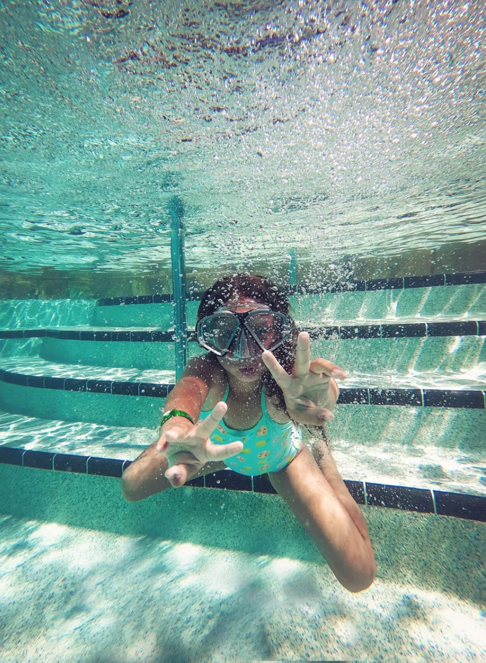 person swimming under water during daytime