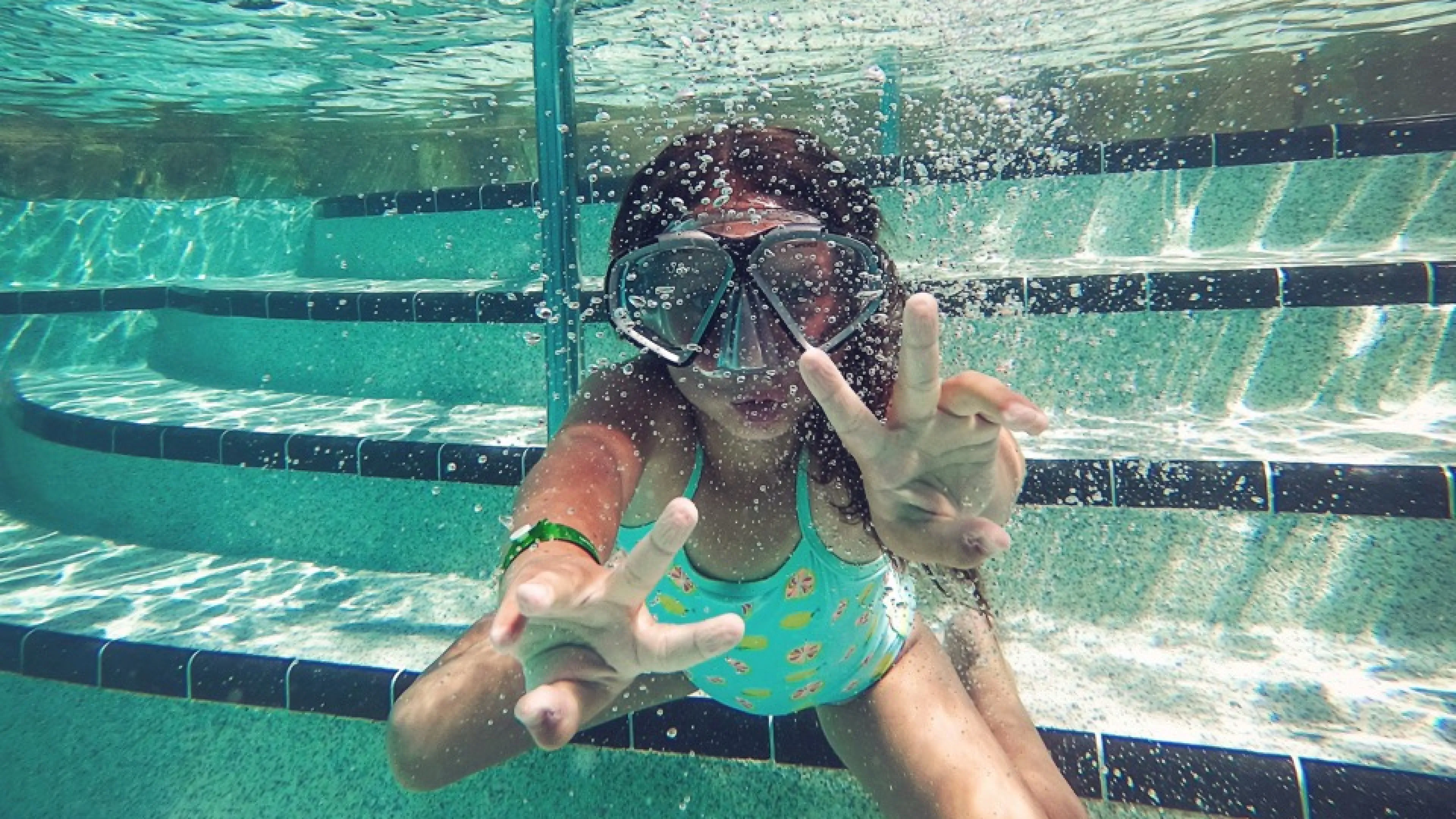 person swimming under water during daytime