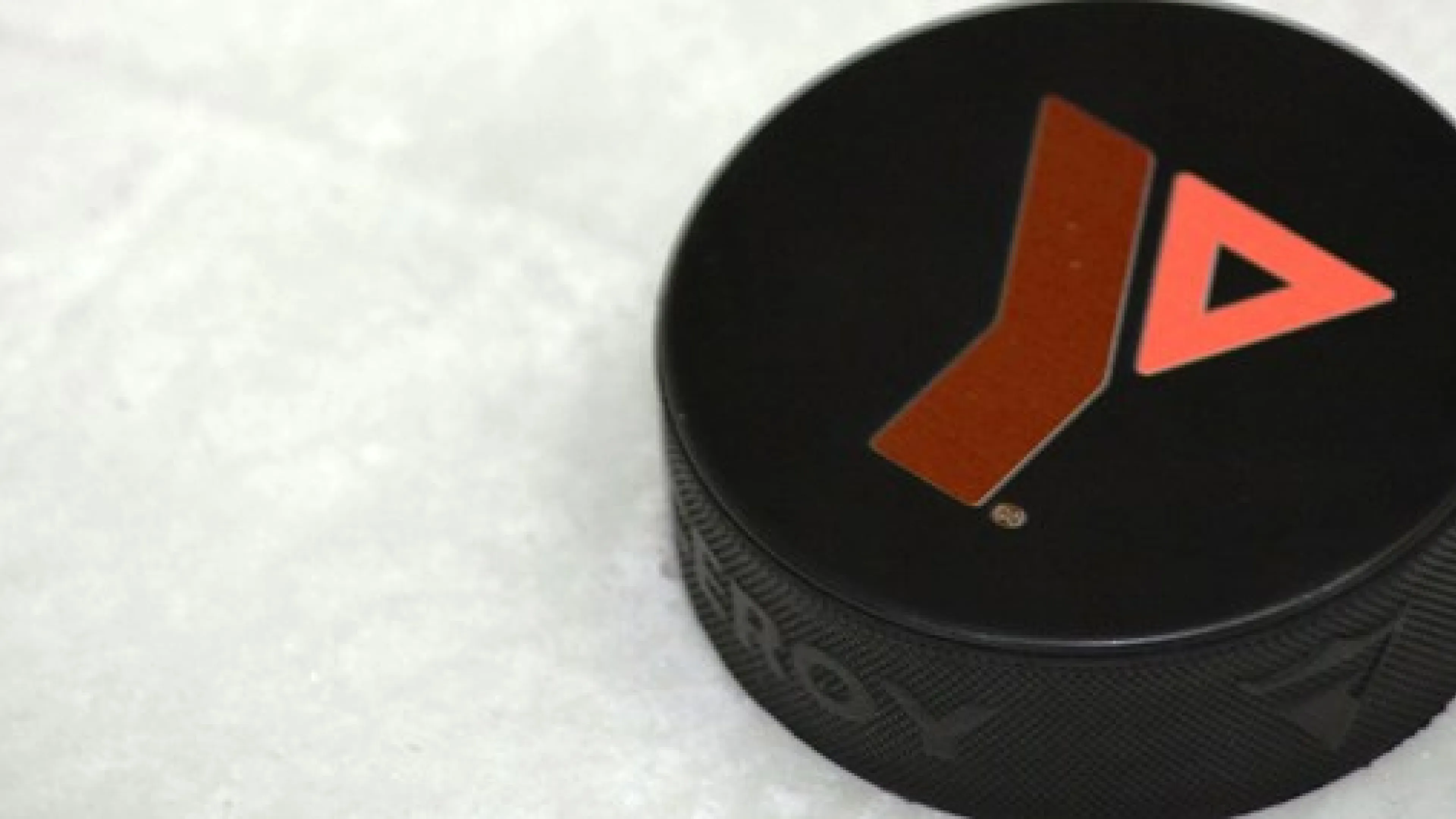 A hockey puck with the Y logo