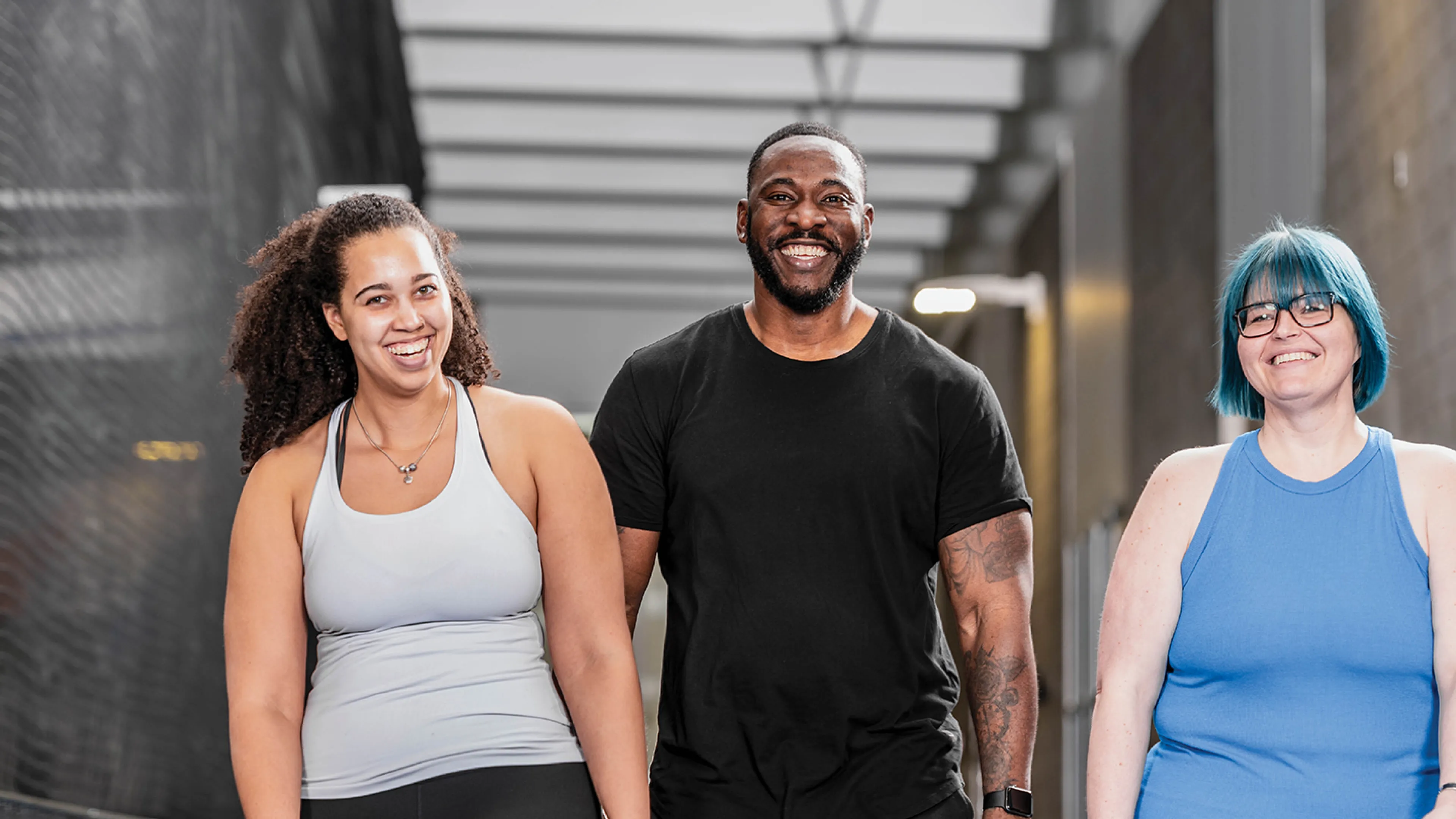 Friends walking in gym.