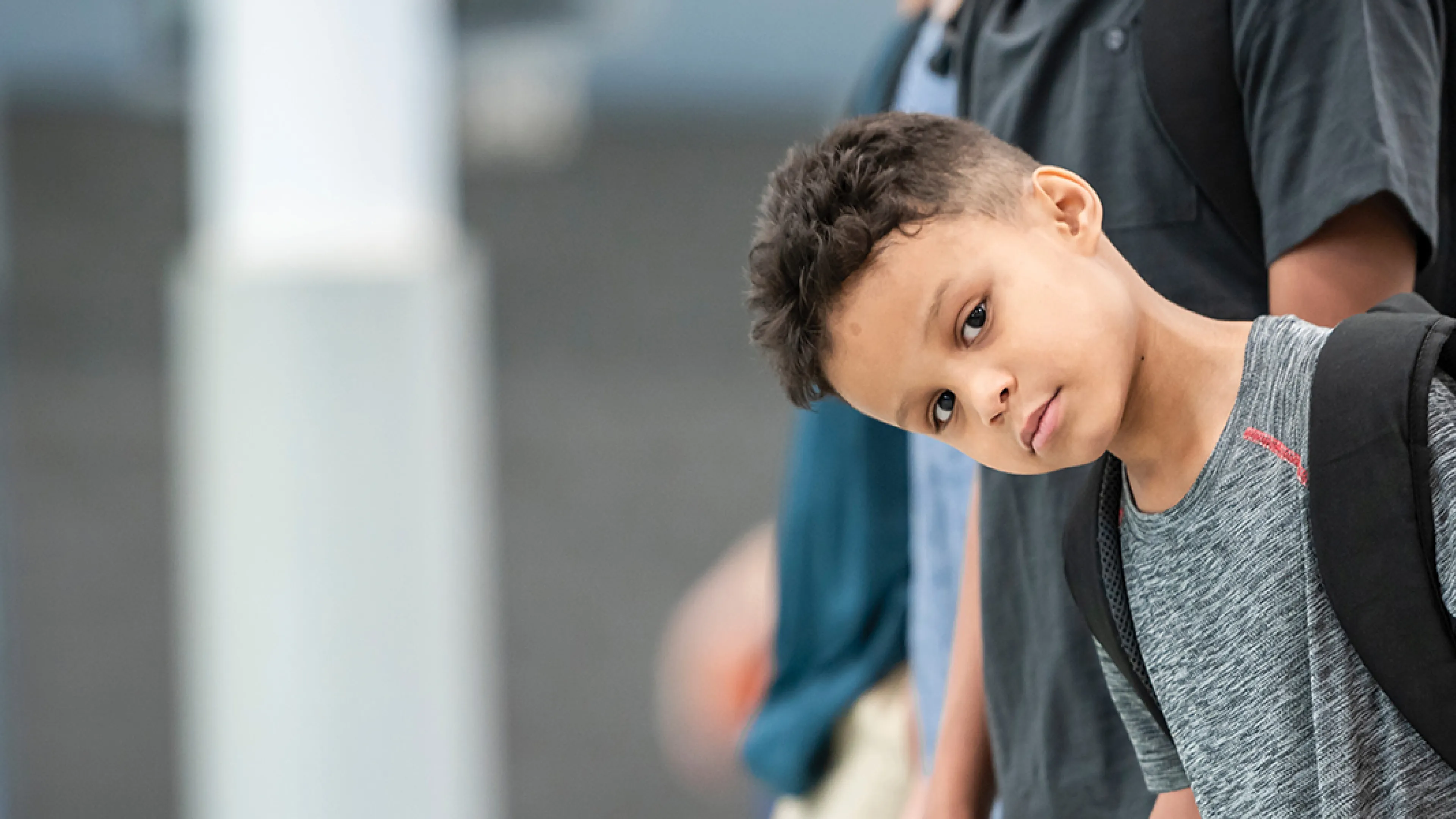 A diverse group of children lined up, all looking forward with cheerful expressions