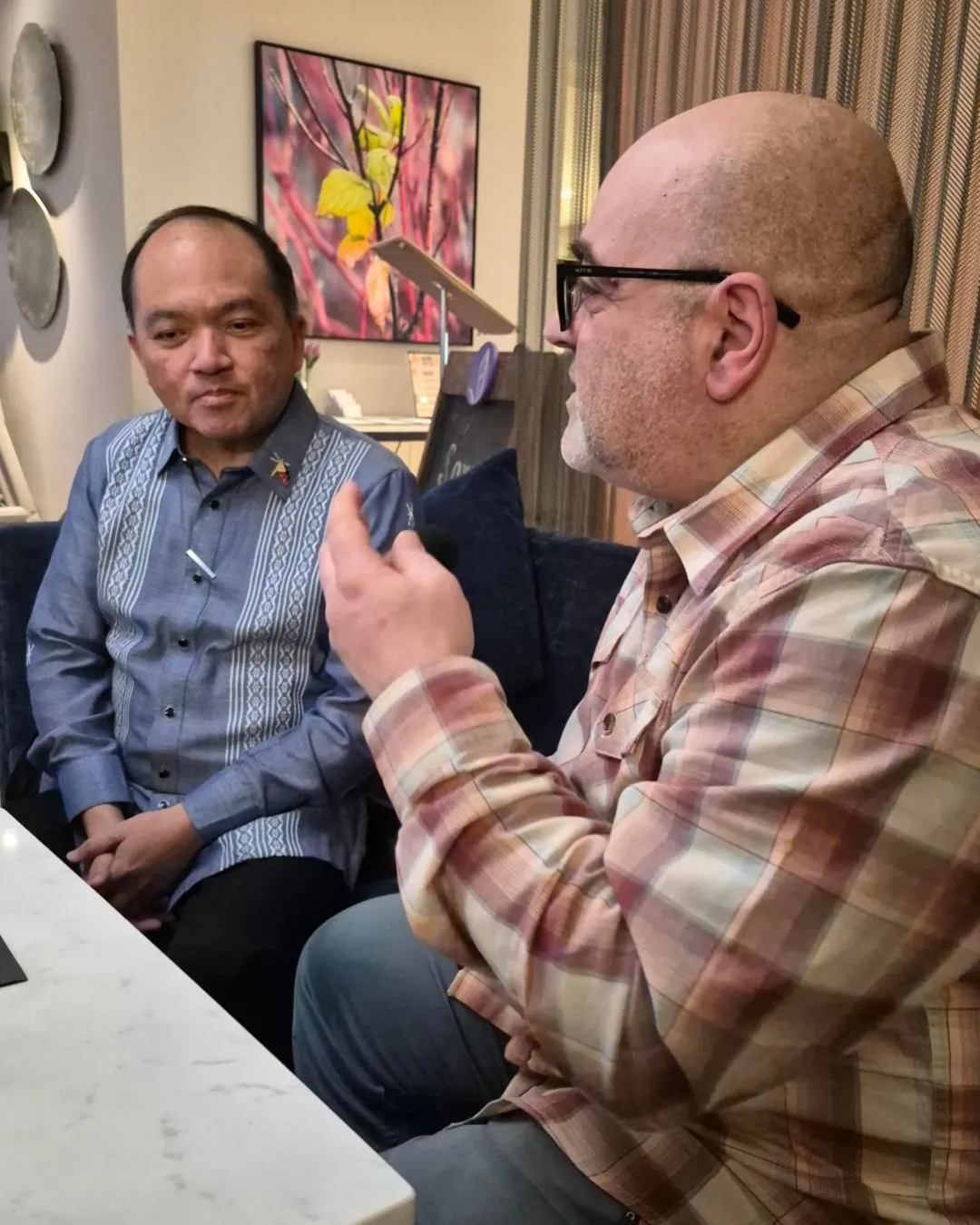 CBC's Mario Carlucci talking to Philippine Ambassador Jose Victor V. Chan-Gonzaga. They are sitting on a couch.