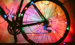 A bicycle wheel decorated with colourful lights.