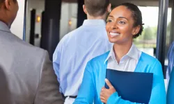 Professional young woman greeting someone at a networking event