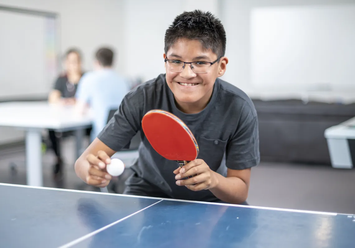 Boy playing table tennis