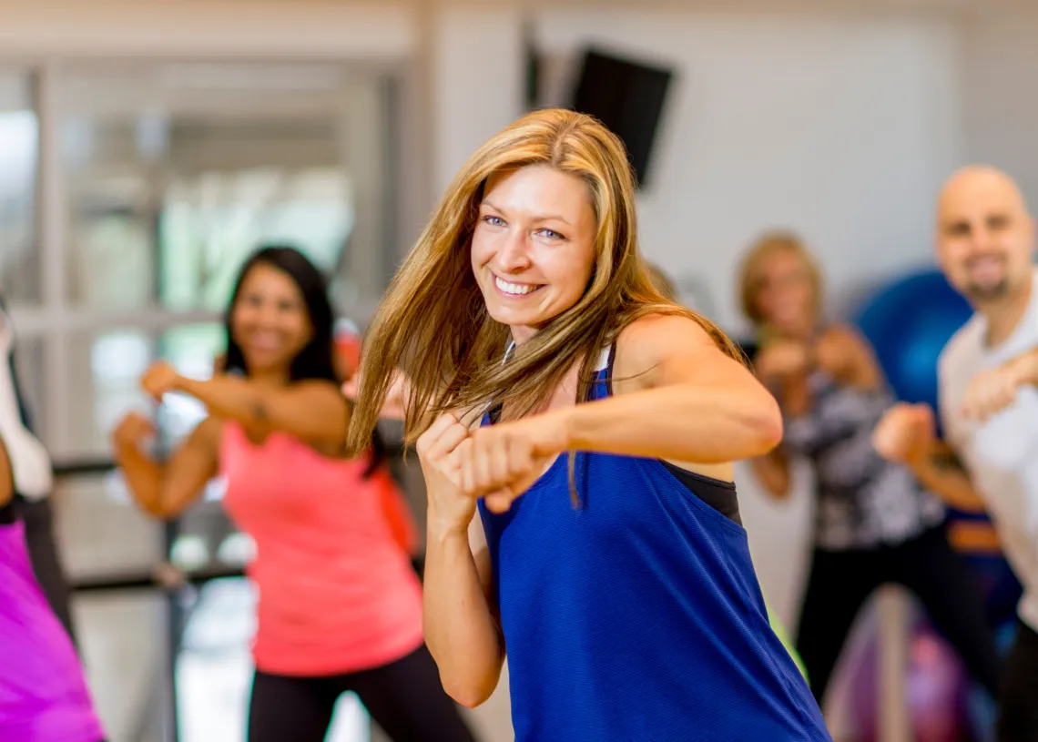 A woman in a group fitness class