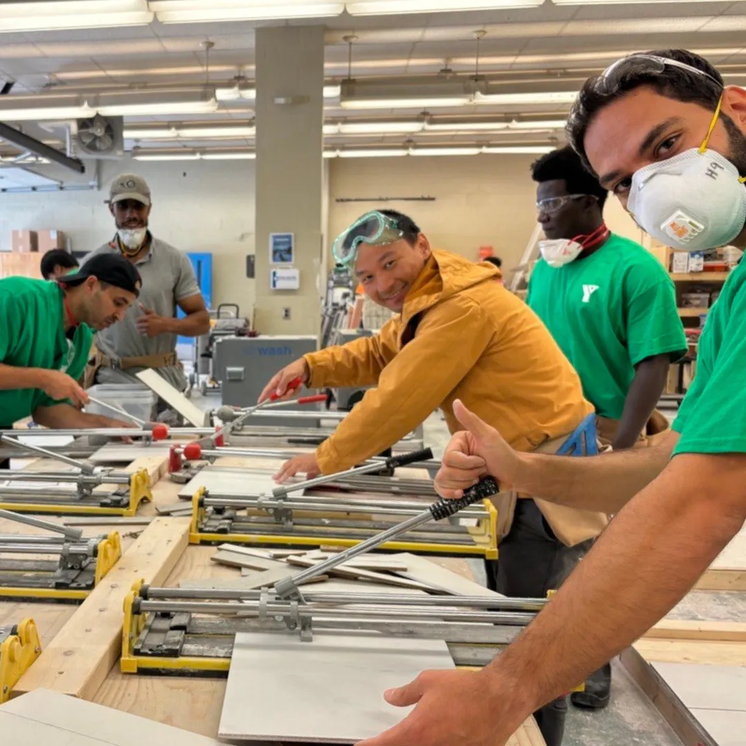 Trades training participants woodworking at a table