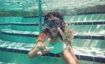 person swimming under water during daytime